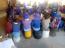 Primary school pupils use buckets as chairs